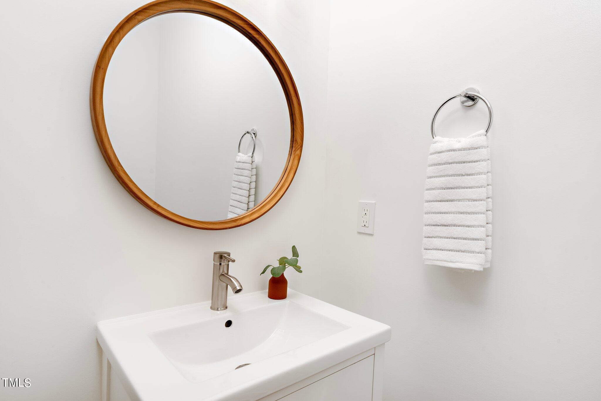 8112 Rhudy Place Raleigh, NC 27612 - Photo 21 of 39 a bathroom with a sink and a mirror