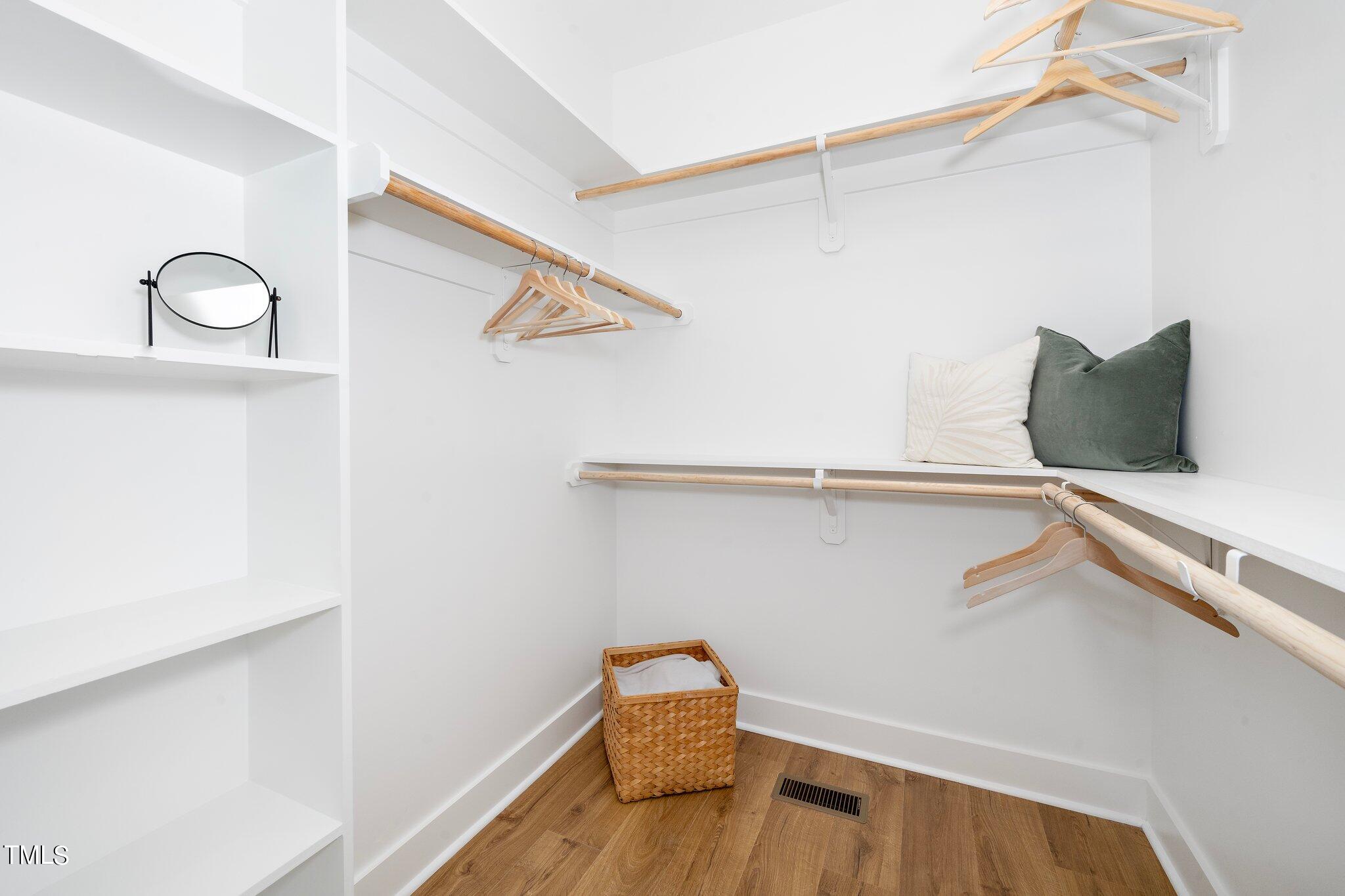 8112 Rhudy Place Raleigh, NC 27612 - Photo 23 of 39 a view of walk in closet with clothes and shoes