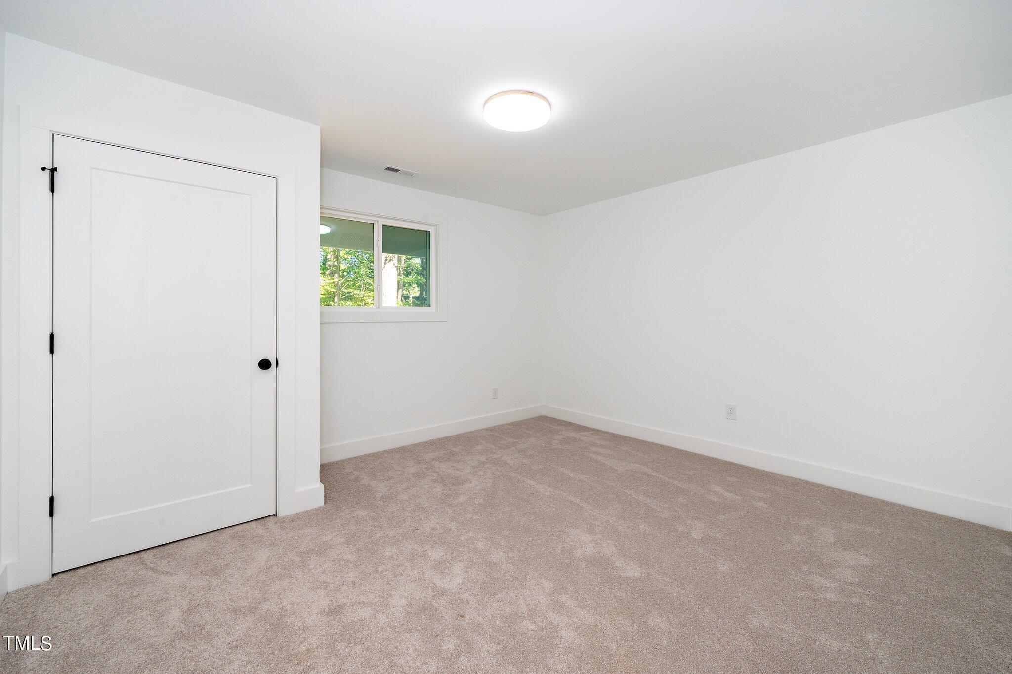 8112 Rhudy Place Raleigh, NC 27612 - Photo 26 of 39 an empty room with windows