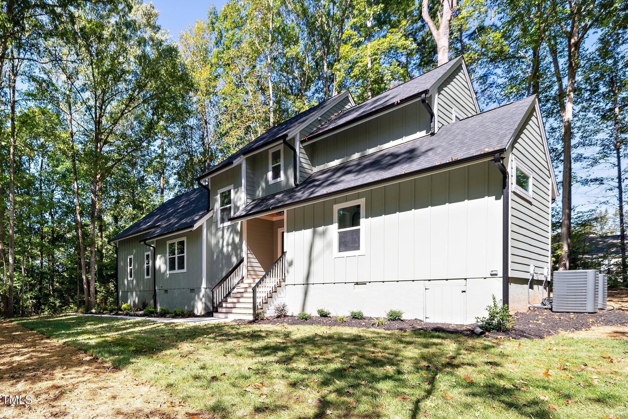 8112 Rhudy Place Raleigh, NC 27612 - Photo 29 of 39 a house that has a tree in front of the house