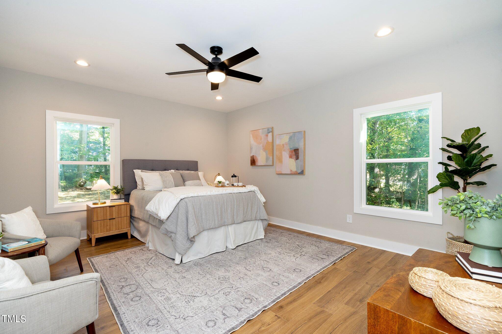 8112 Rhudy Place Raleigh, NC 27612 - Photo 5 of 39 a bedroom with a large bed and a window