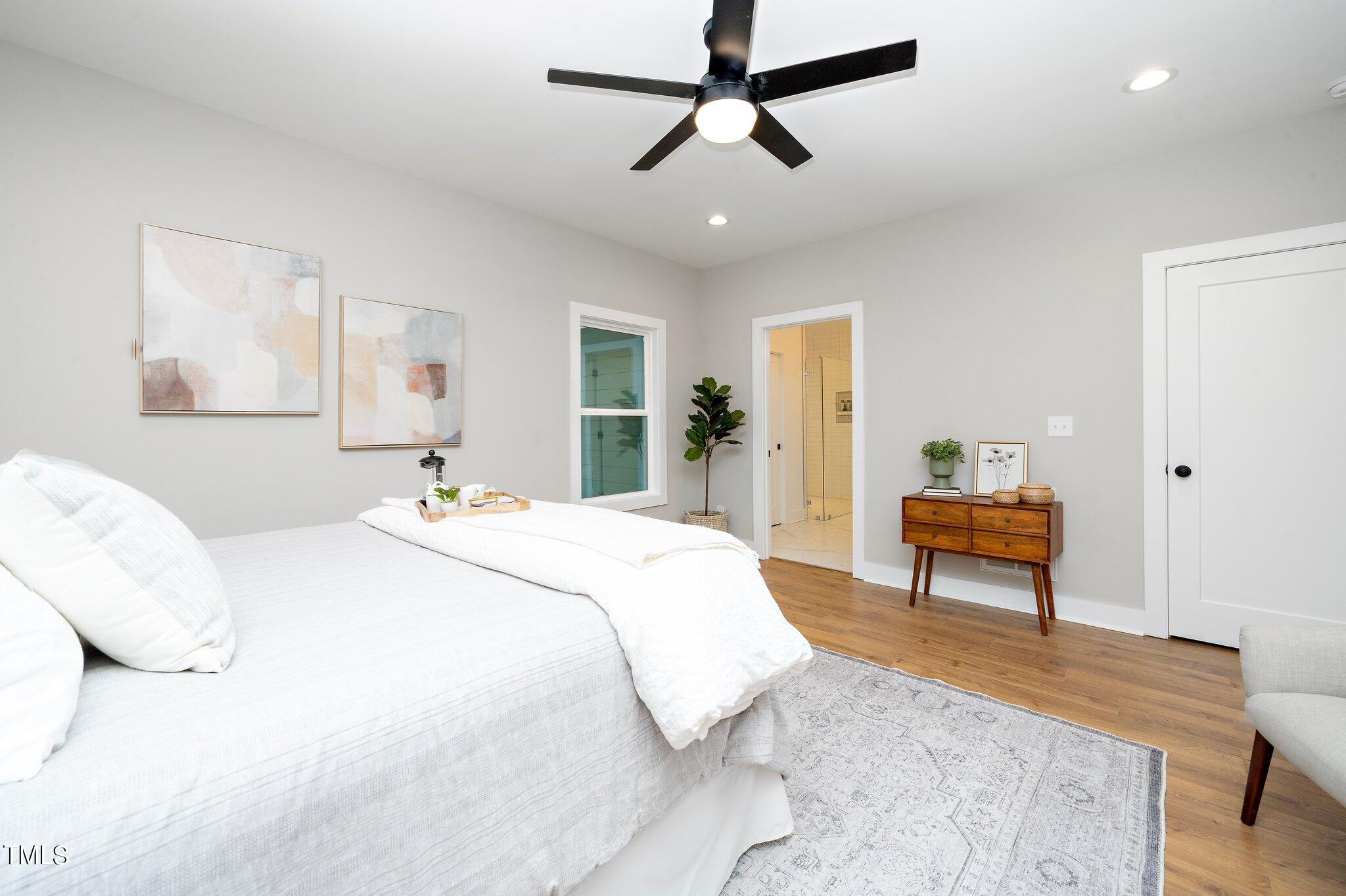 8112 Rhudy Place Raleigh, NC 27612 - Photo 6 of 39 a bedroom with a bed and a dresser