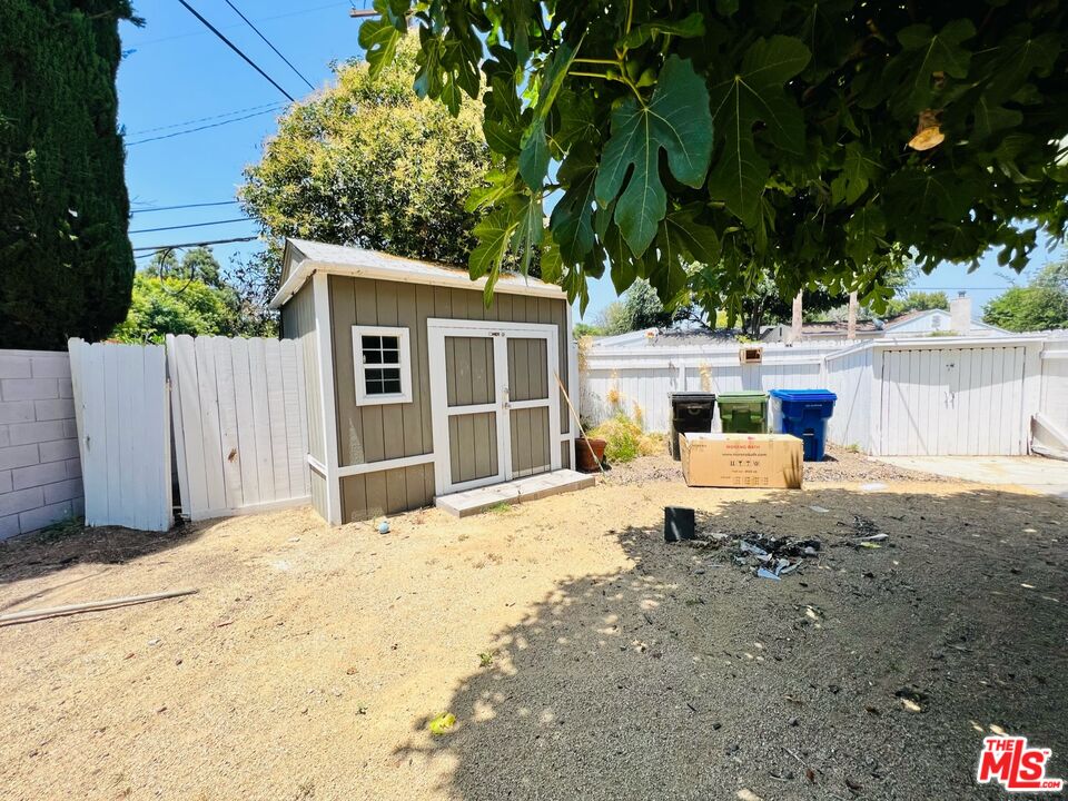 5757 Vesper Avenue Van Nuys, CA 91411 - Photo 16 of 18 a front view of a house with a yard and garage