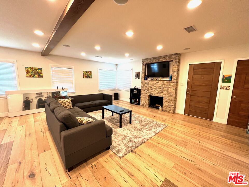 5757 Vesper Avenue Van Nuys, CA 91411 - Photo 3 of 18 a living room with furniture and a flat screen tv