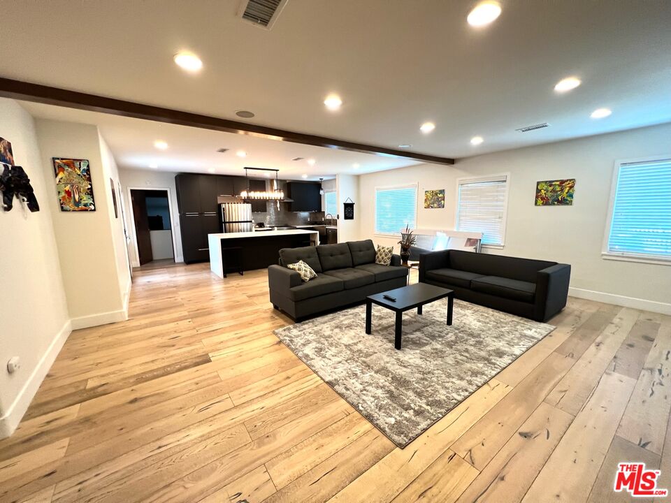 5757 Vesper Avenue Van Nuys, CA 91411 - Photo 7 of 18 a living room with furniture and a wooden floor