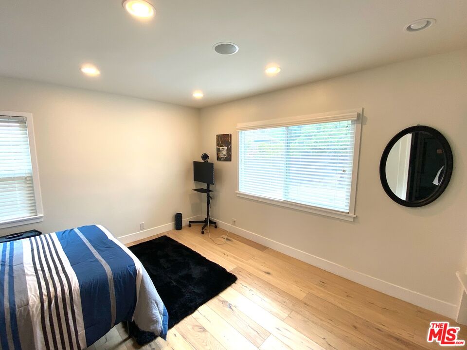 5757 Vesper Avenue Van Nuys, CA 91411 - Photo 8 of 18 a bedroom with a bed and a window