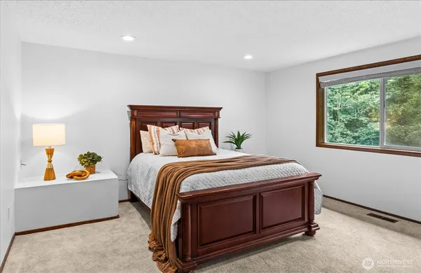 a bedroom with a bed and a window