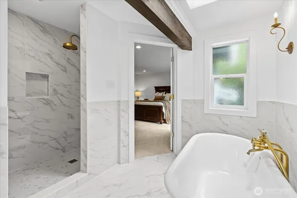 a bathroom with a tub sink and mirror