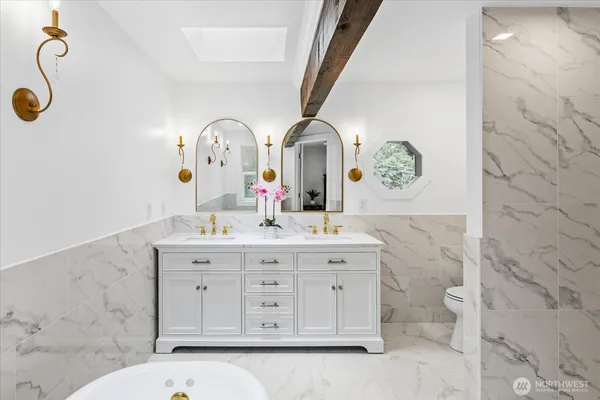a bathroom with a sink mirror and toilet