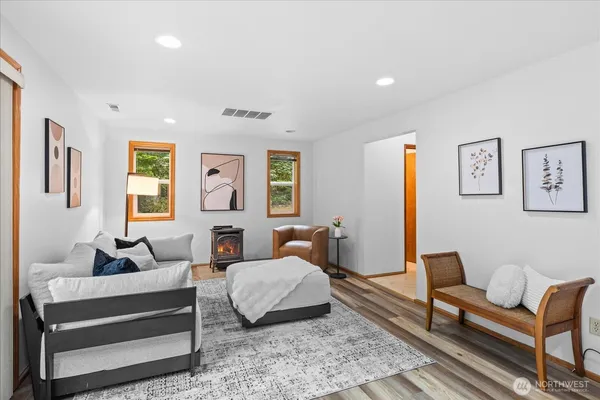 a bedroom with furniture and wooden floor