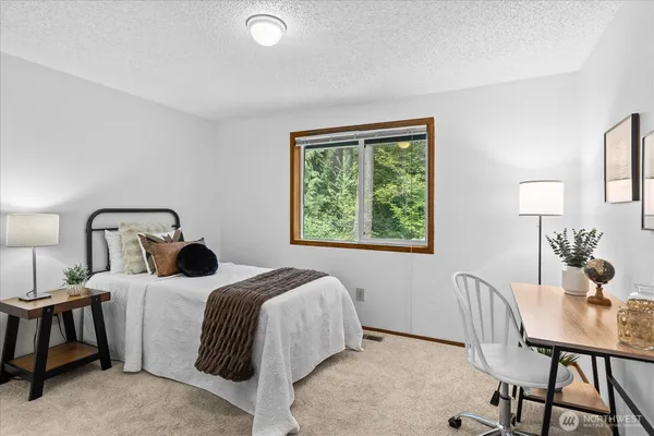 a bed room with a bed and a table