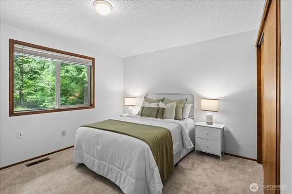 a bedroom with a bed and a window