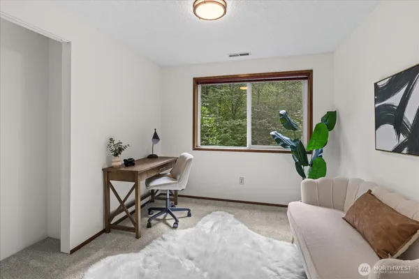 a living room with furniture and a potted plant