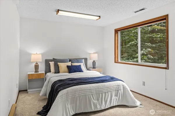 a bedroom with a bed and a window