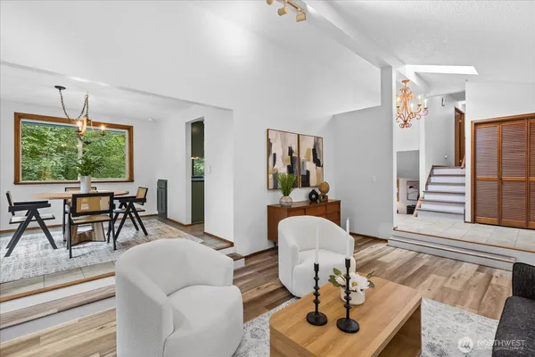 a living room with furniture a window and dining table