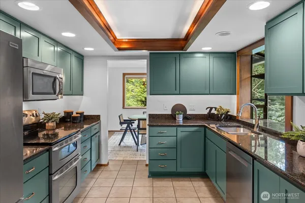 a kitchen with lots of counter top space and stainless steel appliances