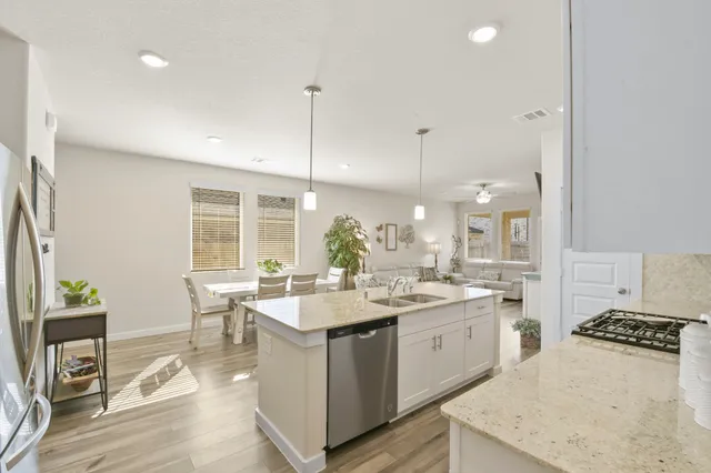 a view of washer and dryer with bathroom in the background
