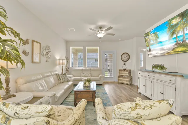 a living room with furniture and a chandelier