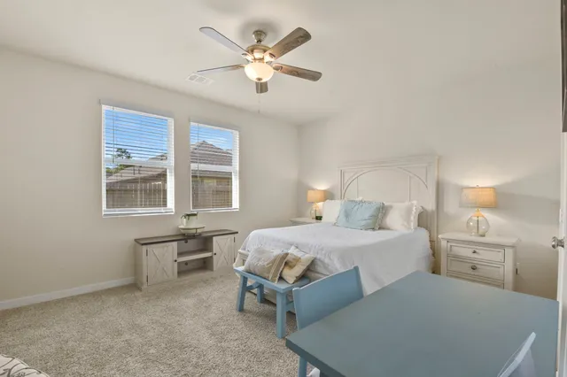 a bedroom with furniture and a ceiling fan