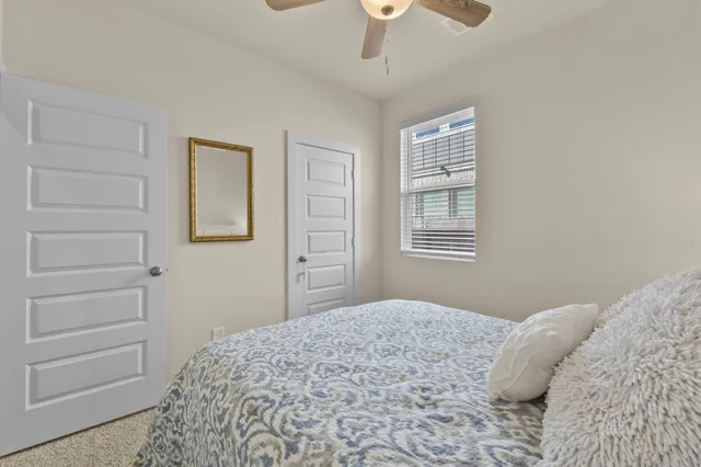 a bathroom with a sink a toilet a mirror a bathtub and shower