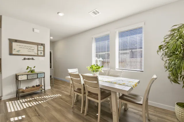 a kitchen with kitchen island granite countertop a sink a counter space appliances and cabinets
