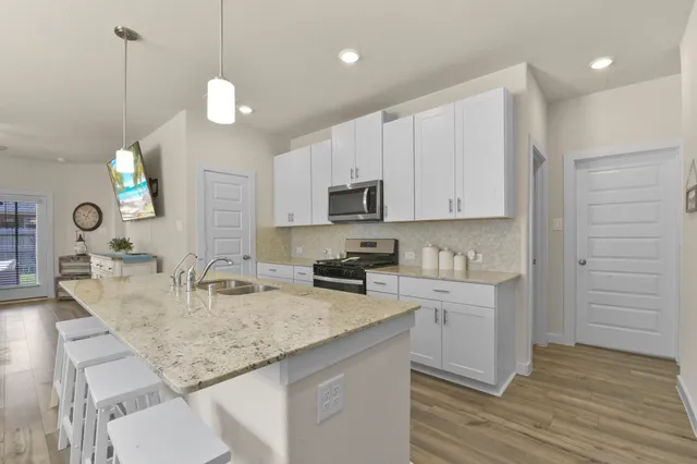 a kitchen with kitchen island cabinets and refrigerator