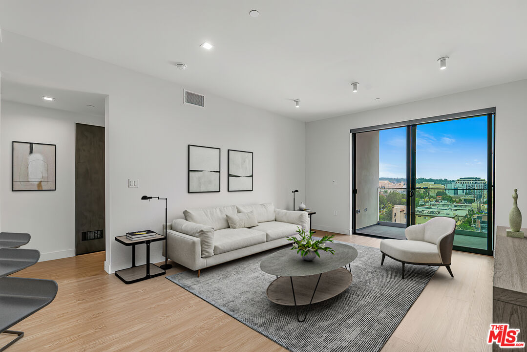 3688 Overland Avenue, Unit 521 Los Angeles, CA 90034 - Photo 2 of 31 a living room with furniture and a large window