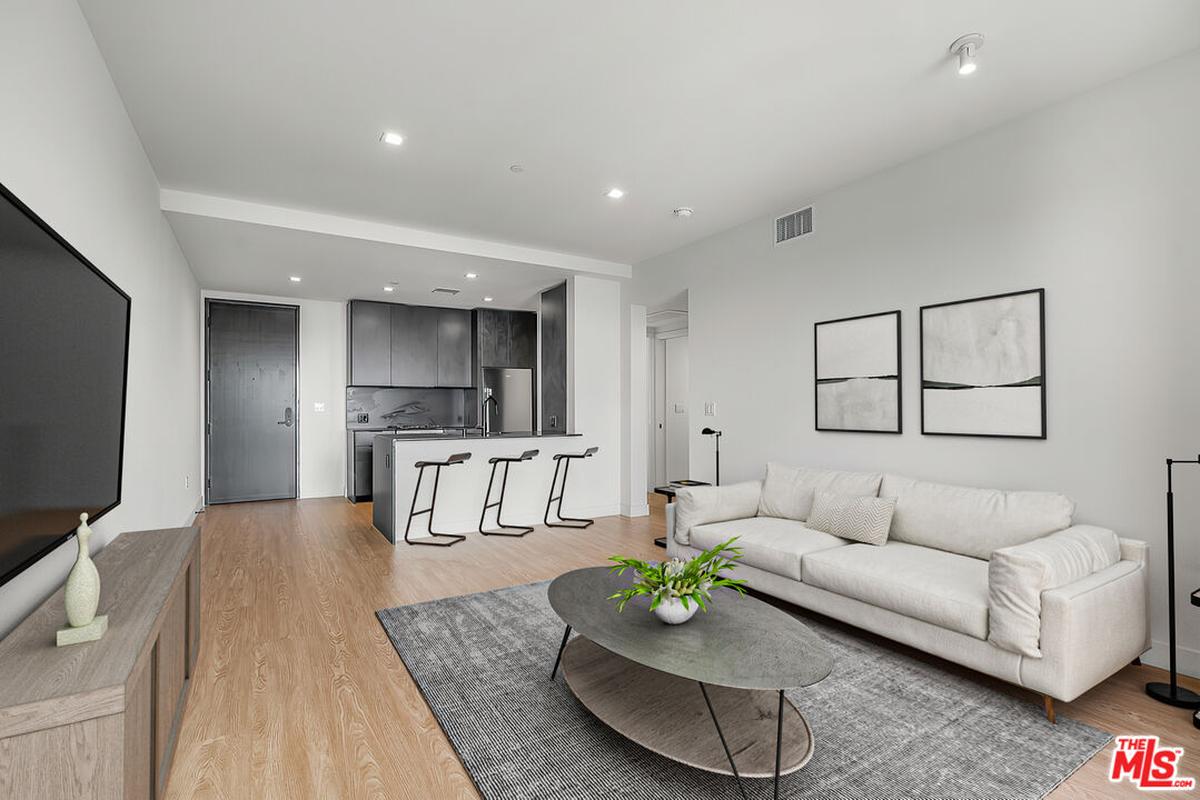 3688 Overland Avenue, Unit 521 Los Angeles, CA 90034 - Photo 4 of 31 a living room with furniture and a flat screen tv