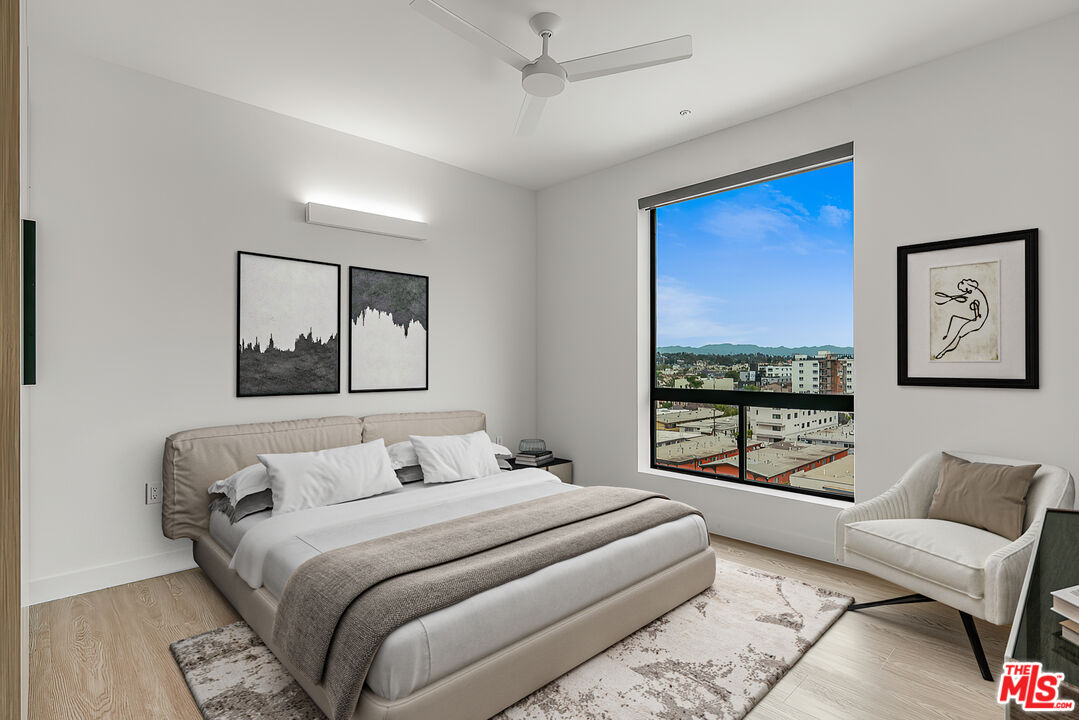 3688 Overland Avenue, Unit 521 Los Angeles, CA 90034 - Photo 5 of 31 a bedroom with a large bed couch and two windows
