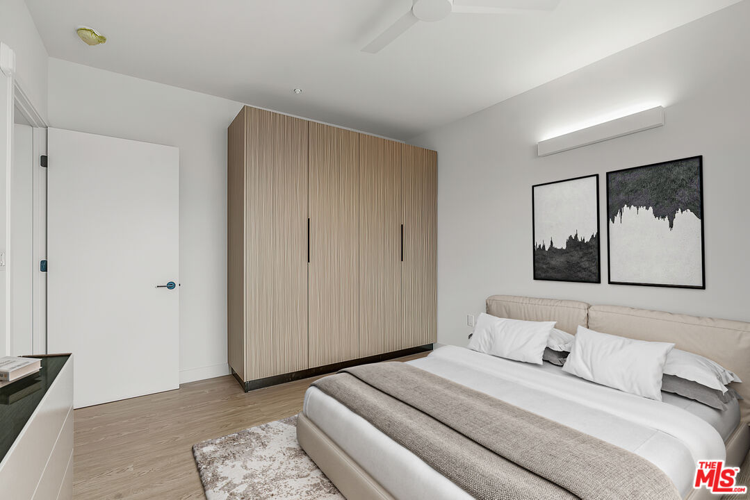 3688 Overland Avenue, Unit 521 Los Angeles, CA 90034 - Photo 6 of 31 a bedroom with a bed and a painting on the wall