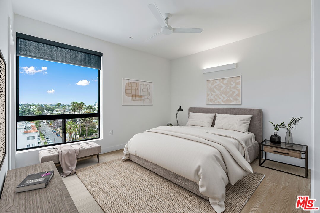 3688 Overland Avenue, Unit 521 Los Angeles, CA 90034 - Photo 9 of 31 a bedroom with a bed and a large window