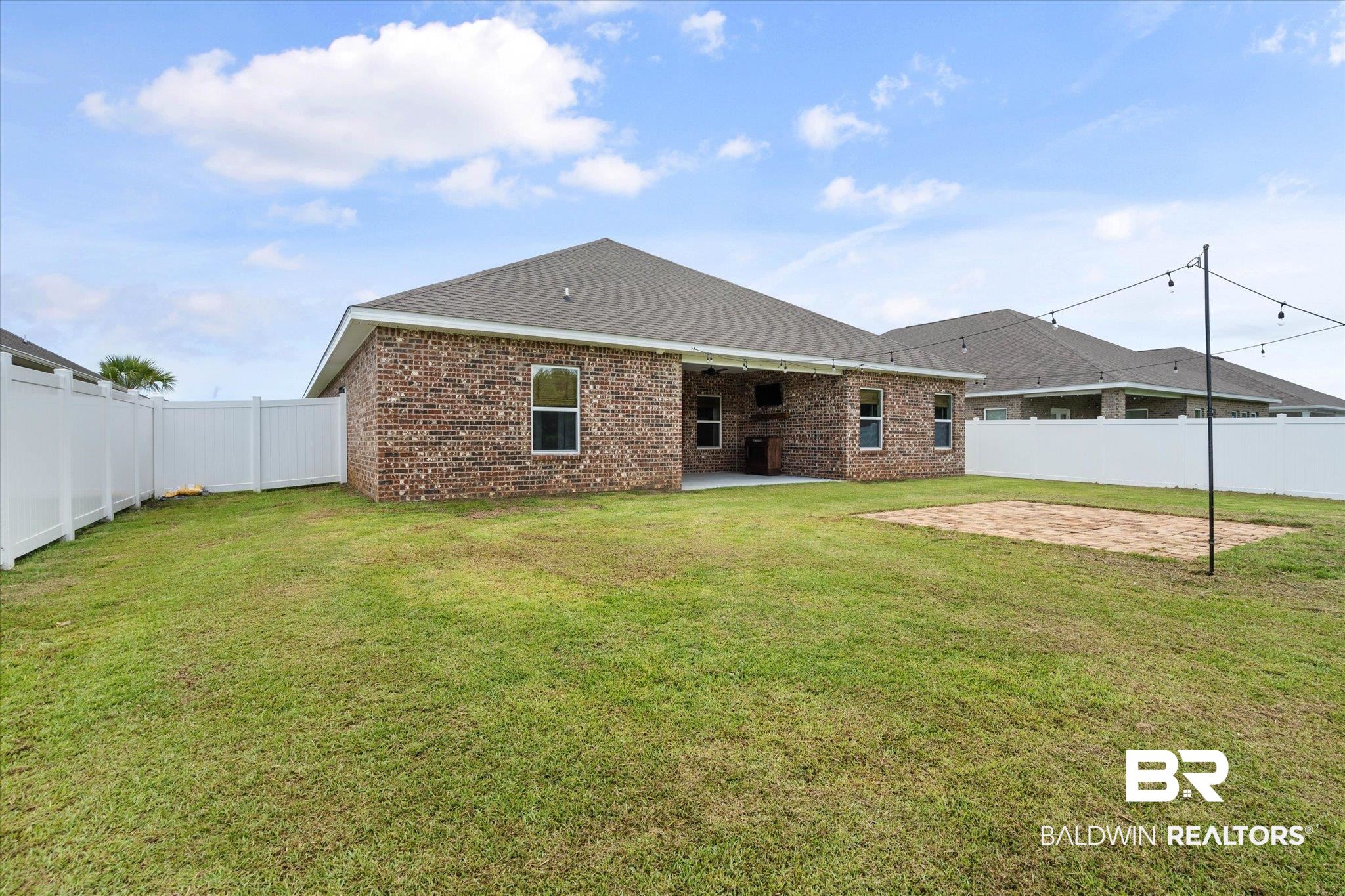 11229 Genuine Risk Circle Daphne, AL 36526 - Photo 26 of 46 Rear view of house with a patio, brick siding, a fenced backyard, and a shingled roof