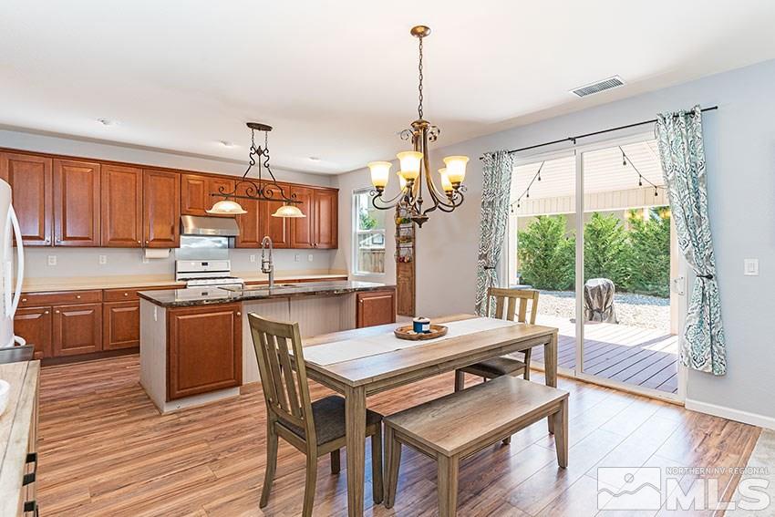 11510 Verazae Drive Reno, NV 89521 - Photo 5 of 15 a kitchen with a table chairs stove and wooden floor