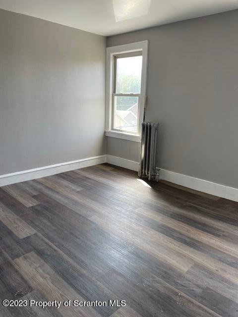 1225 South Main Street, Unit 6 Old Forge, PA 18518 - Photo 3 of 9 an empty room with wooden floor and windows