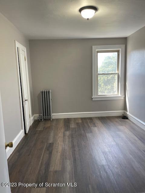 1225 South Main Street, Unit 6 Old Forge, PA 18518 - Photo 5 of 9 an empty room with wooden floor and window