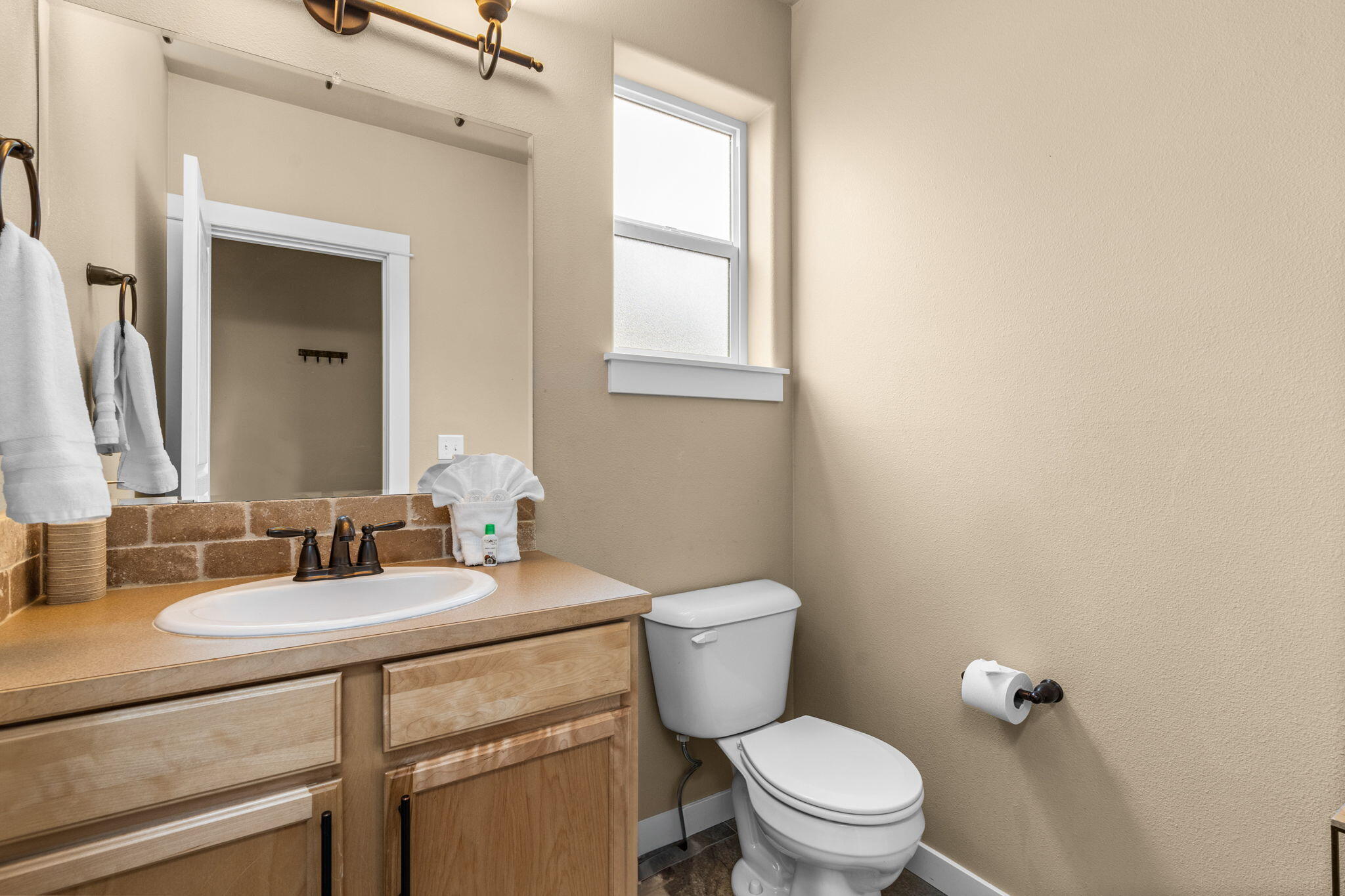 2781 Northeast Spring Water Place Bend, OR 97701 - Photo 12 of 23 a bathroom with a granite countertop toilet sink and mirror