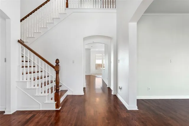 a view of an entryway with wooden floor and stairs
