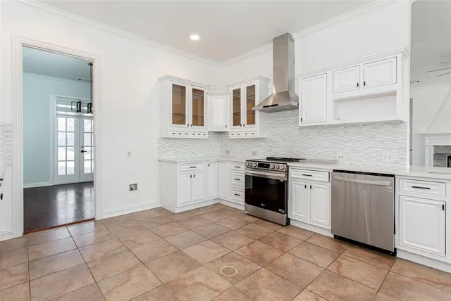 a kitchen with stainless steel appliances granite countertop a stove sink and cabinets
