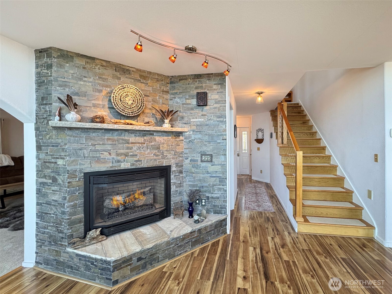 250 North Street, Unit A Sequim, WA 98382 - Photo 22 of 40 a living room with a fireplace and a wooden floor