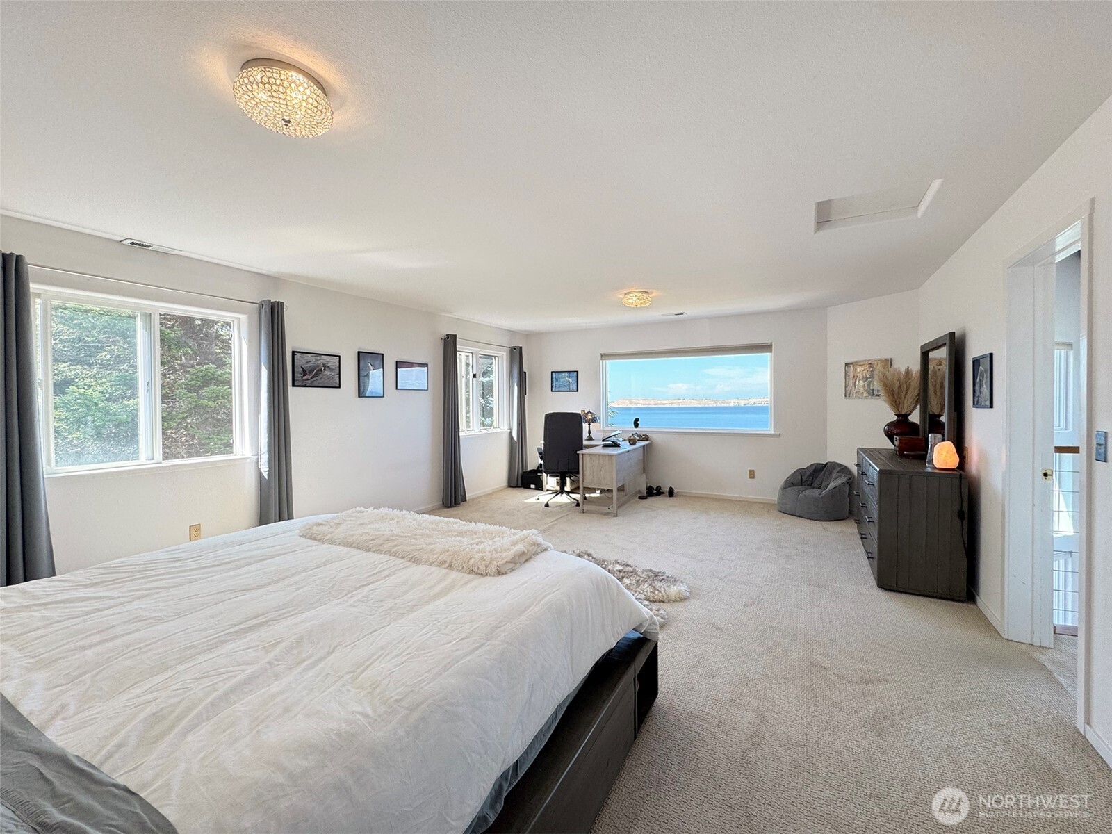 250 North Street, Unit A Sequim, WA 98382 - Photo 32 of 40 a bedroom with a bed and a large window