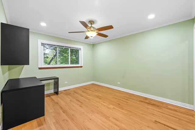 a workspace with wooden floor and windows