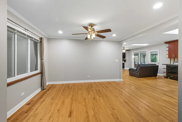 a view of a livingroom with a hardwood floor and a ceiling fan