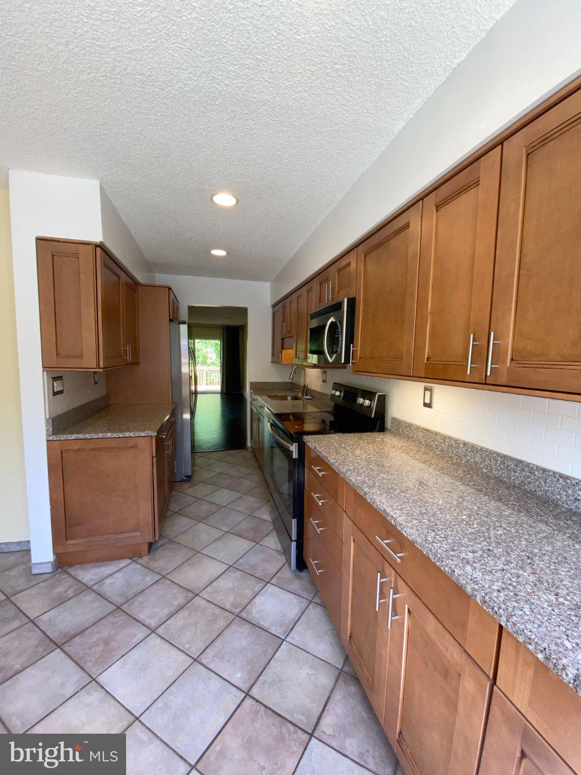 326 Brigade Court Chesterbrook, PA 19087 - Photo 46 of 48 a kitchen with stainless steel appliances granite countertop a stove a sink and a microwave
