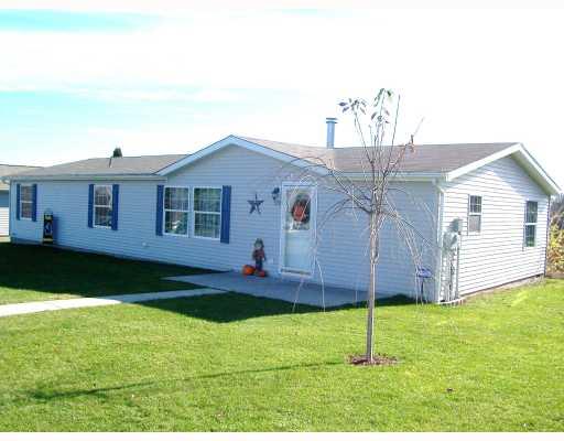 Exterior Front. Beautiful three bedroom two full baths 2006 28x64 Manufactured home with a new two detached garage on .81 acre lot. Tasteful neutral decor. Large eat-in-kitchen with a kitchen island. All new appliances stay with the home.  Home fully appraised. Must See!