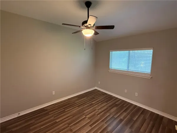 a view of room with window and ceiling fan