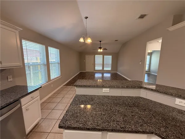 a view of a kitchen with a sink and a window