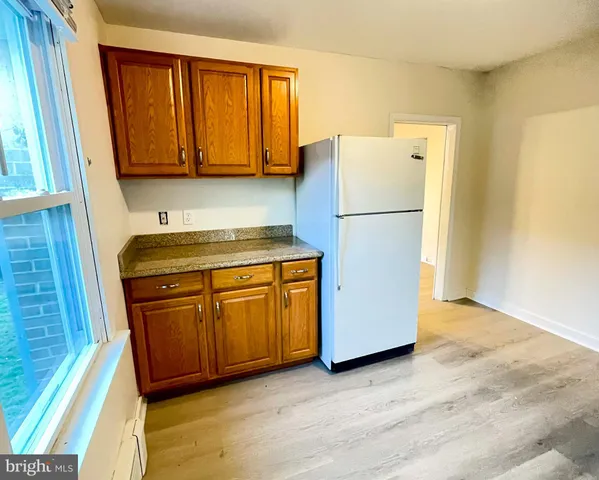 a white refrigerator freezer sitting in a kitchen