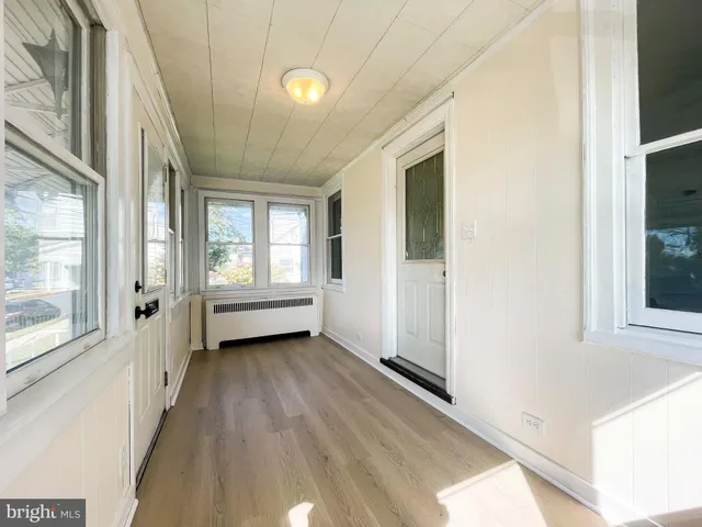 a view of a room with wooden floor and windows