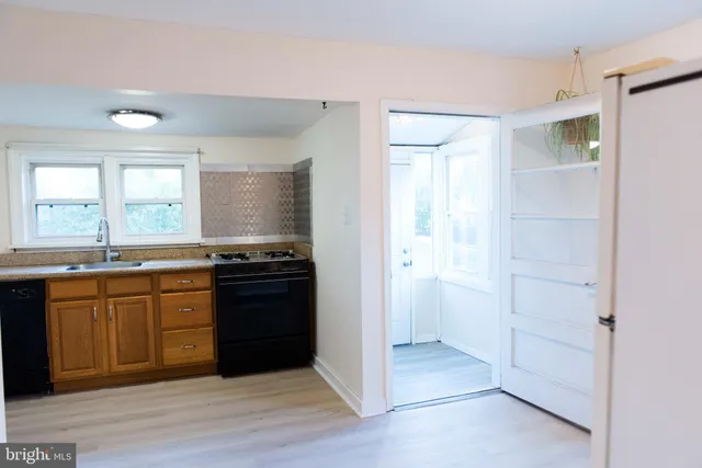 a large kitchen with a stove and a refrigerator