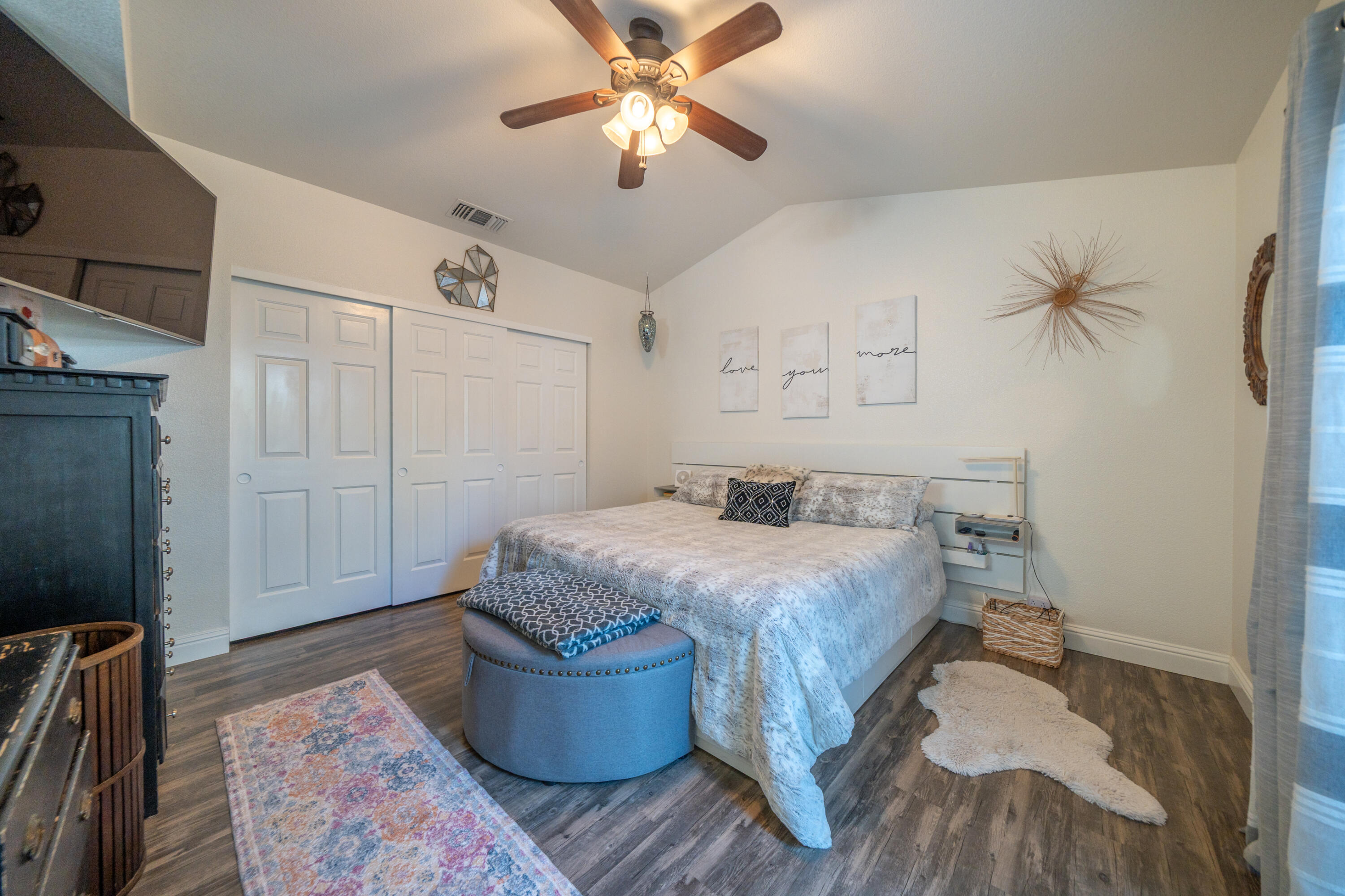 874 Spaniel Drive Redding, CA 96003 - Photo 17 of 41 a bedroom with a bed and a chandelier